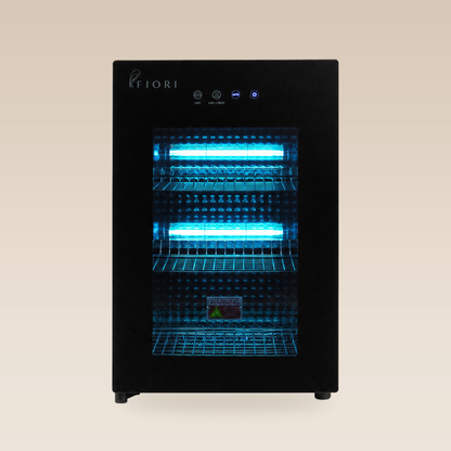 Fiori ST-60L V2 sterilizer, front view with black glass door and dual UV-C lamps illuminated